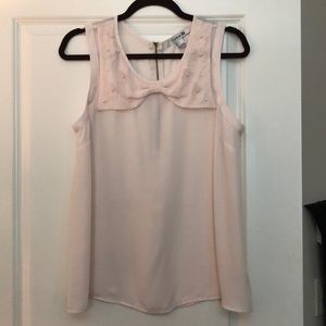 Sleeveless peach blouse w/ pearl detail